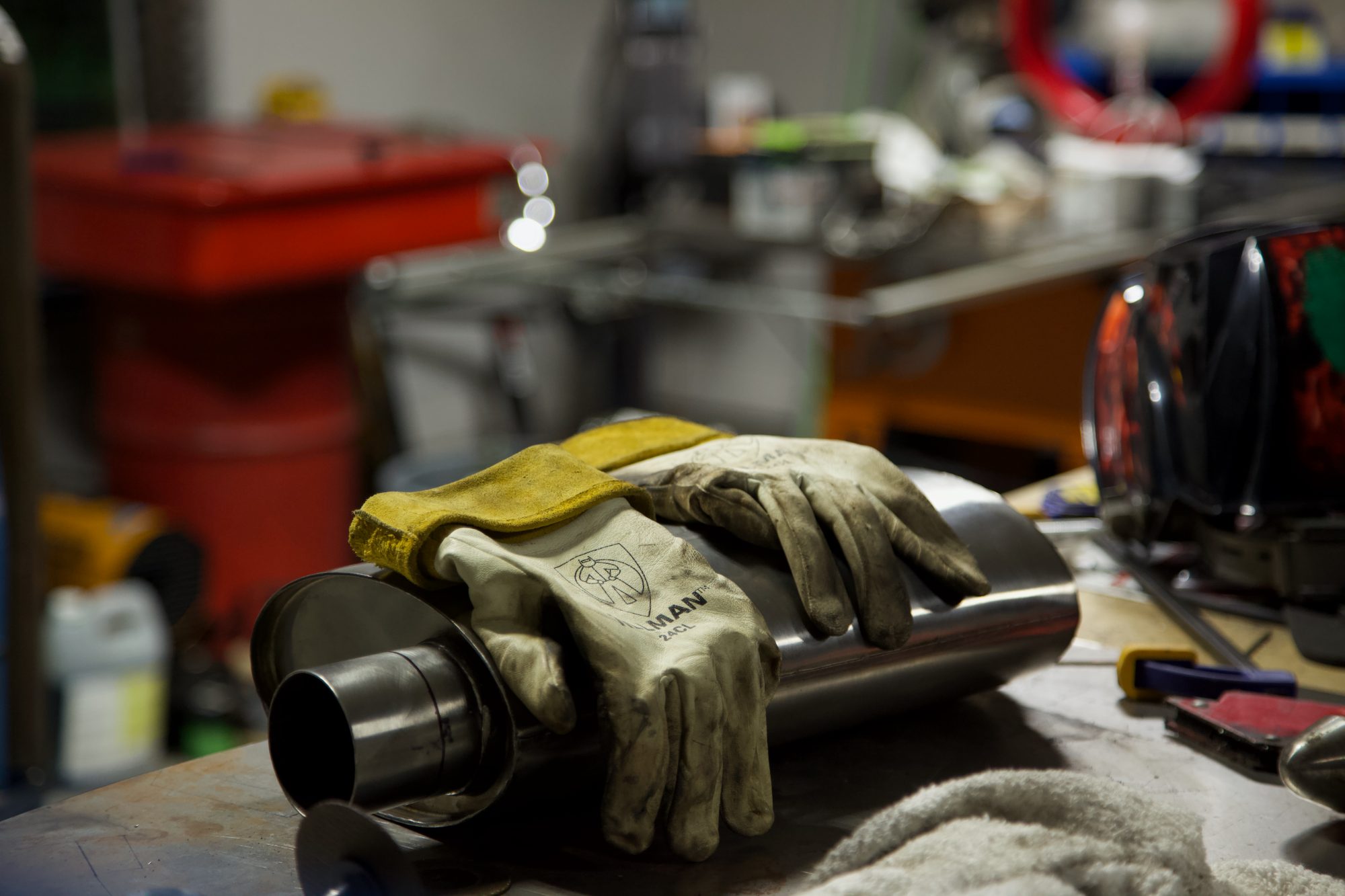 Welding gloves on a muffler — real home mechanic work