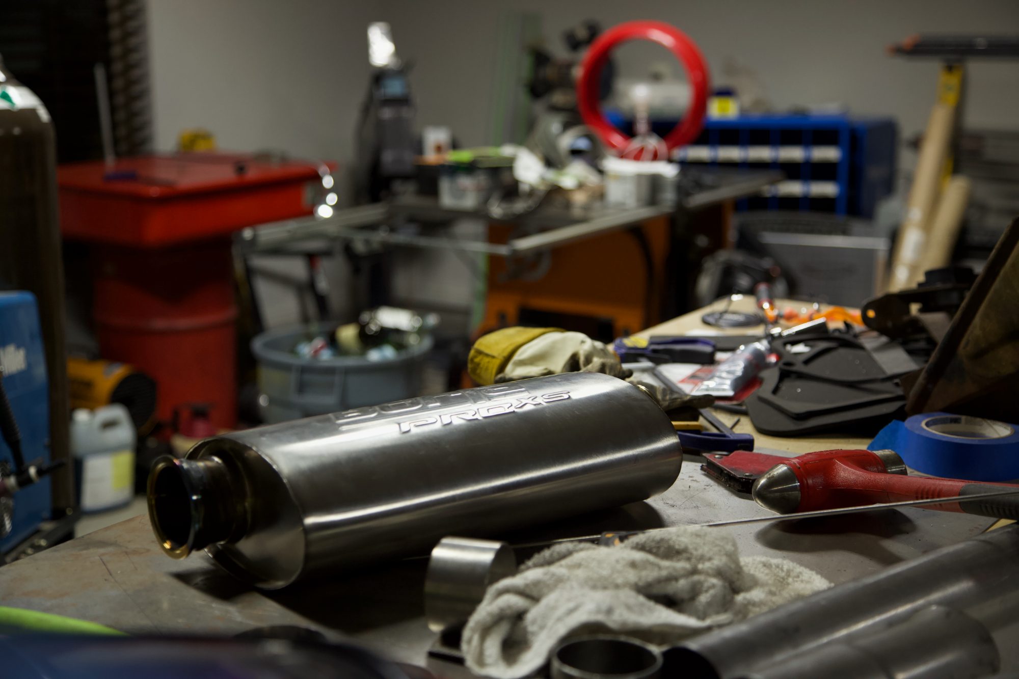 Stainless muffler and parts on the bench